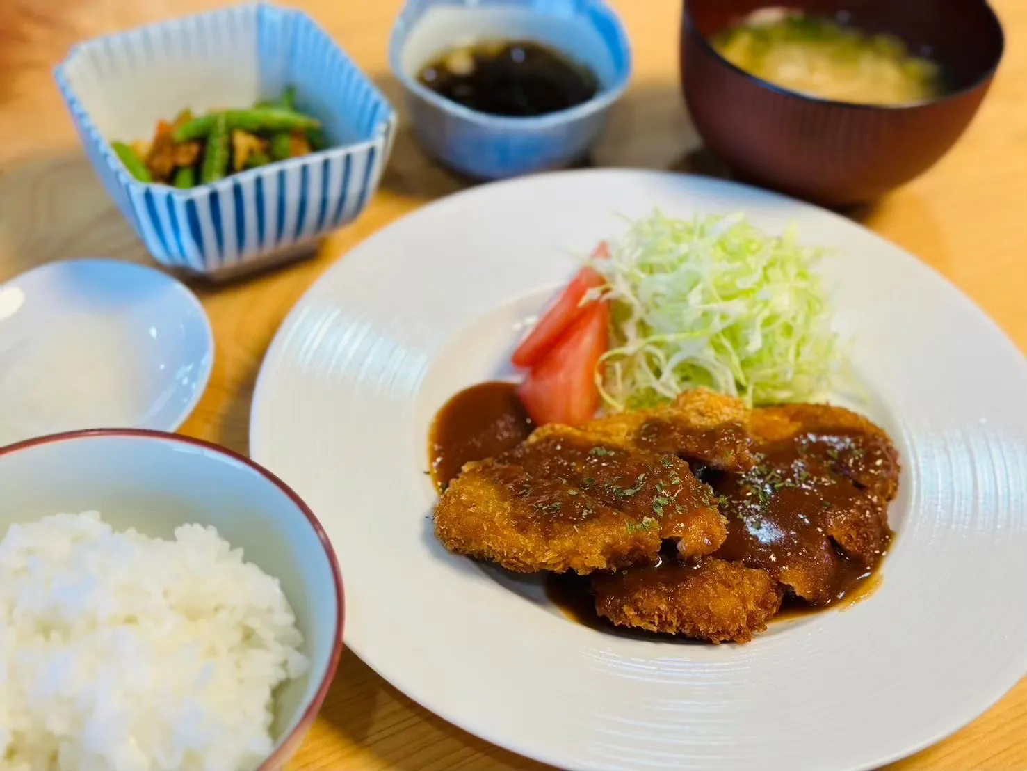 カツと千切りキャベツ、ごはん、副菜、汁物が並ぶWILLの昼食